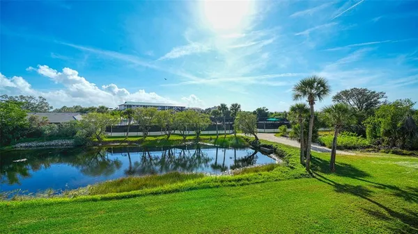 a view of a lake with houses in the background
