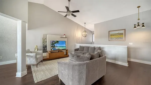 a living room with furniture and a chandelier