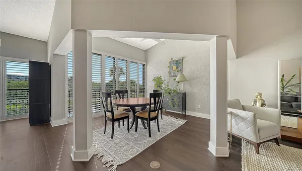 a view of a dining room with furniture and wooden floor