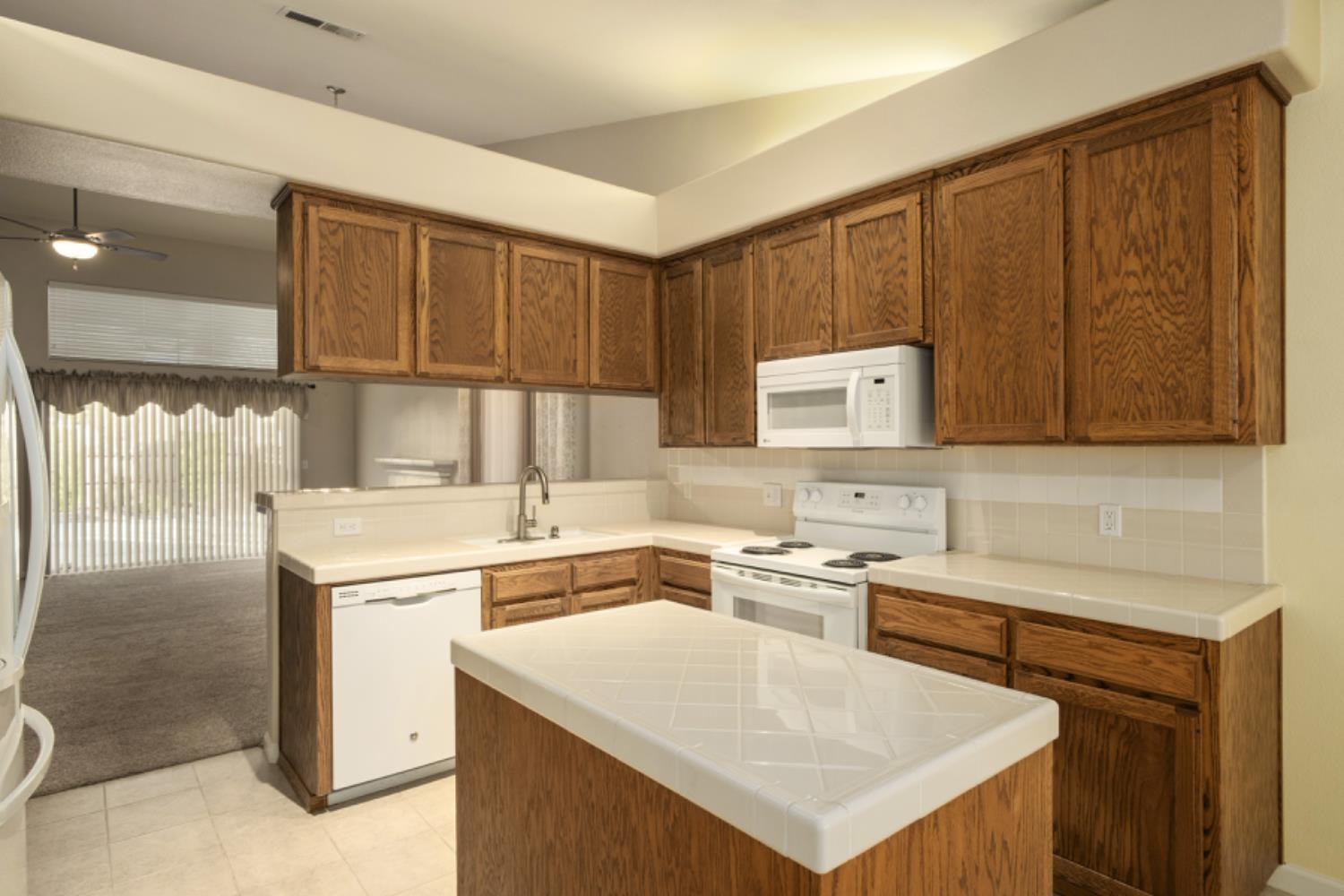 793 Applegate Avenue Clovis, CA 93611 - Photo 11 of 20 a kitchen that has a sink a stove and a microwave oven in it