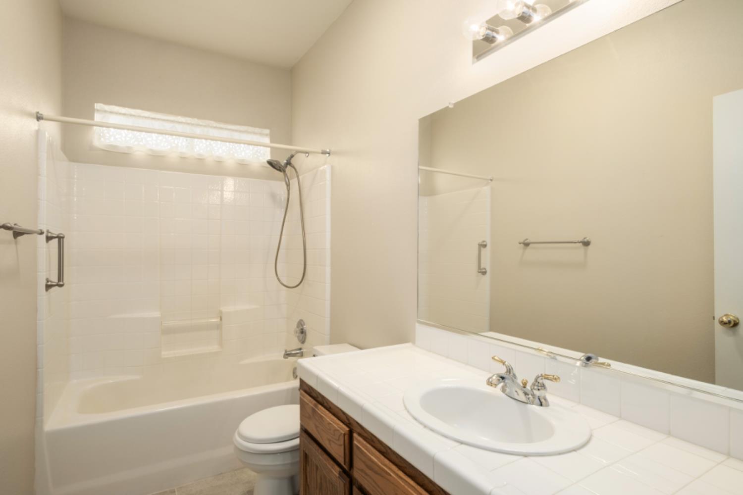 793 Applegate Avenue Clovis, CA 93611 - Photo 18 of 20 a bathroom with a sink toilet and shower