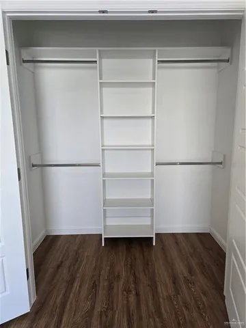 a view of a room with wooden floor