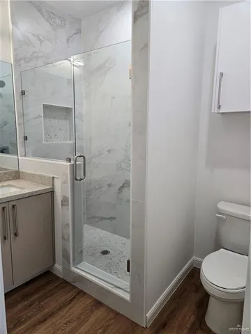 a bathroom with a shower a toilet and a sink