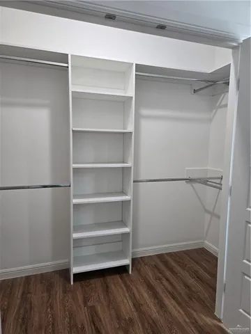a view of walk in closet with empty racks