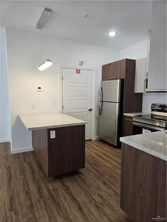 a kitchen with stainless steel appliances a refrigerator and a stove