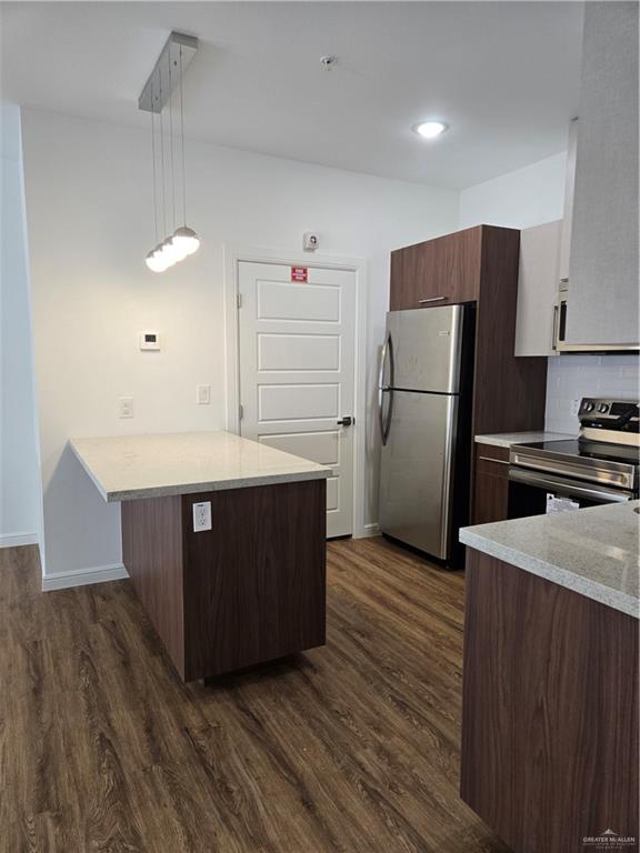 901 East Yuma Avenue, Unit 207 McAllen, TX 78503 - Photo 5 of 21 a kitchen with stainless steel appliances a refrigerator and a stove