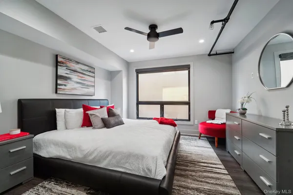 a bed room with a bed mirror and a window