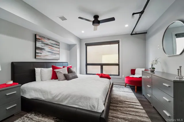 a bed room with a bed mirror and a window