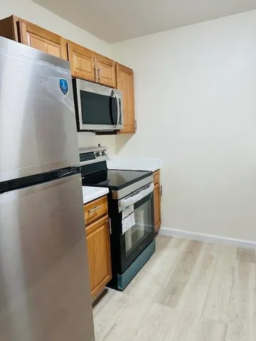 a kitchen with stainless steel appliances granite countertop a sink and a microwave