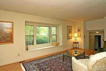 4409 Old Colony Road Raleigh, NC 27613 - Photo 4 of 10 a bedroom with a bed and wooden floor