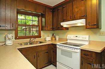 4409 Old Colony Road Raleigh, NC 27613 - Photo 7 of 10 a kitchen with a sink stove and cabinets