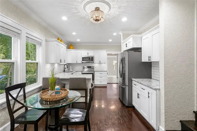 a spacious bedroom with a large bed and ceiling fan