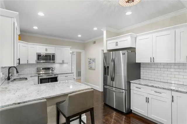 a view of a hallway with wooden floor and windows