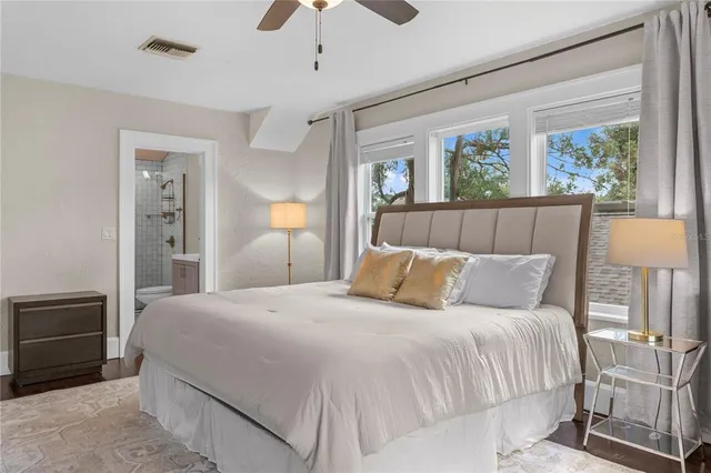 a bedroom with a bed and a large window