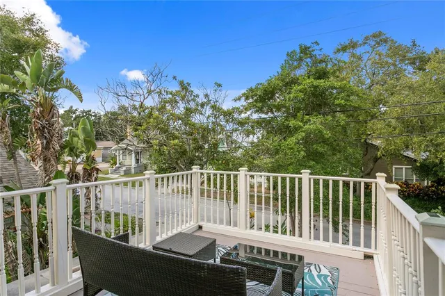 a dining room with furniture a chandelier and wooden floor