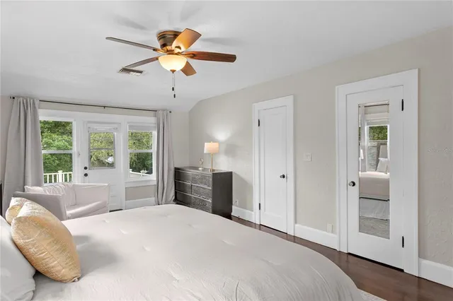 a dining room with furniture a chandelier and wooden floor