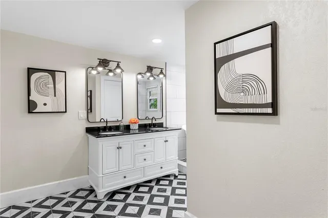a kitchen with granite countertop a sink and a stove