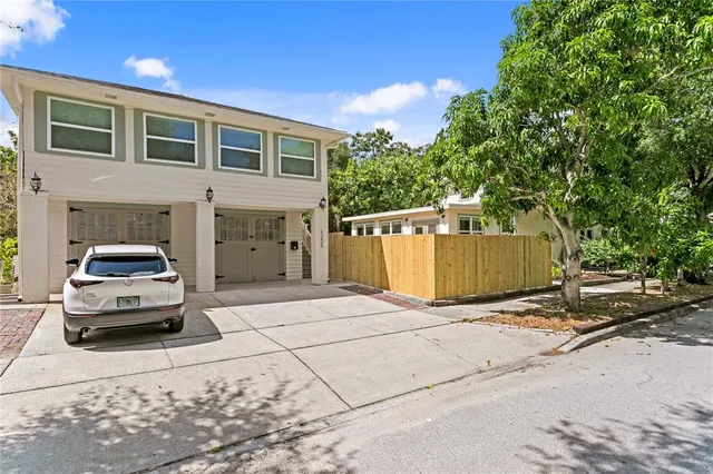a view of a chairs and table in backyard of the house