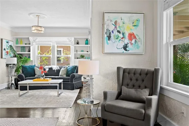 a kitchen with stainless steel appliances kitchen island granite countertop a refrigerator a sink a stove and chairs