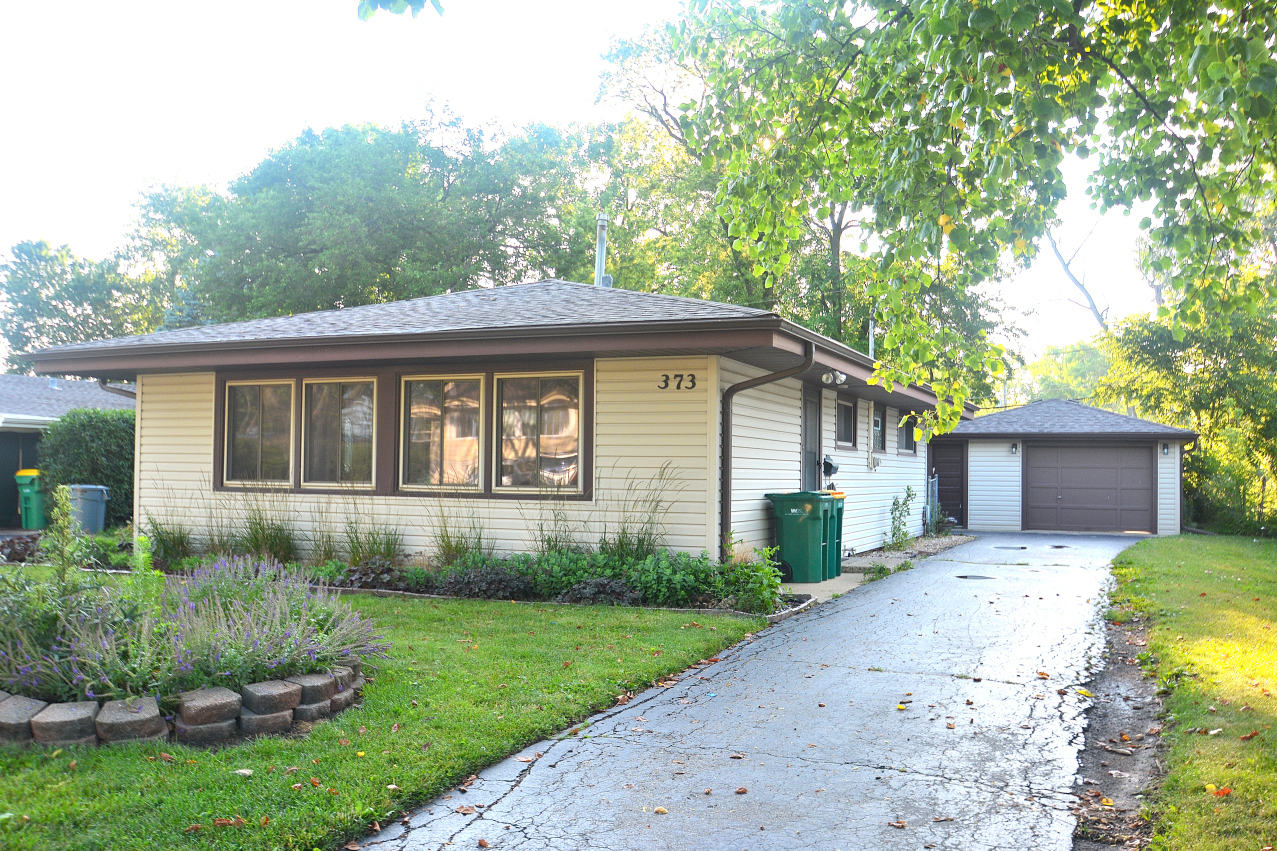 373 Nancy Lane Wheeling, IL 60090 - Photo 1 of 3 a front view of house with yard and green space