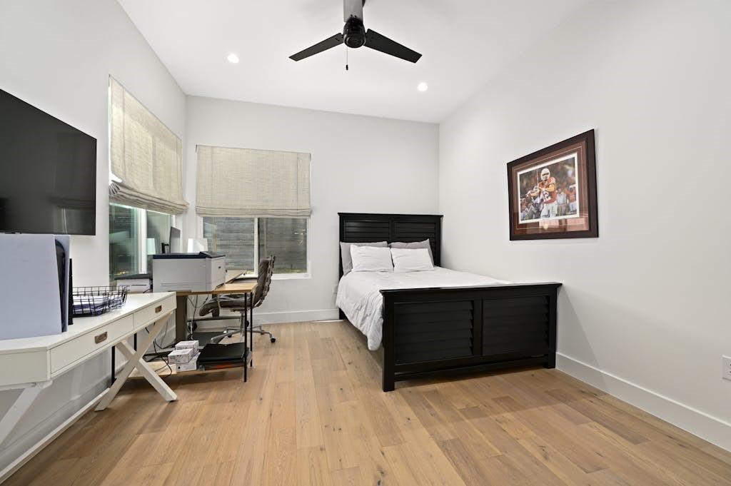 5212 Huisache Street, Unit 2 Austin, TX 78751 - Photo 17 of 30 Bedroom featuring a desk, light wood-type flooring, a ceiling fan, and recessed lighting