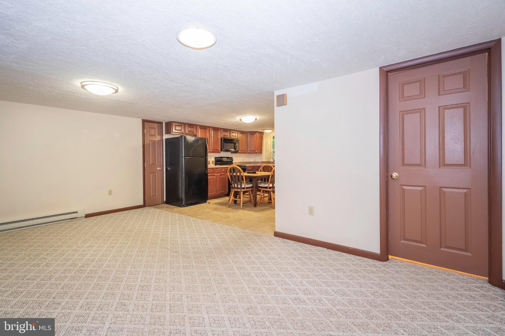 206 Mayhew Inn Road Oakland, MD 21550 - Photo 11 of 31 a view of a livingroom with a refrigerator