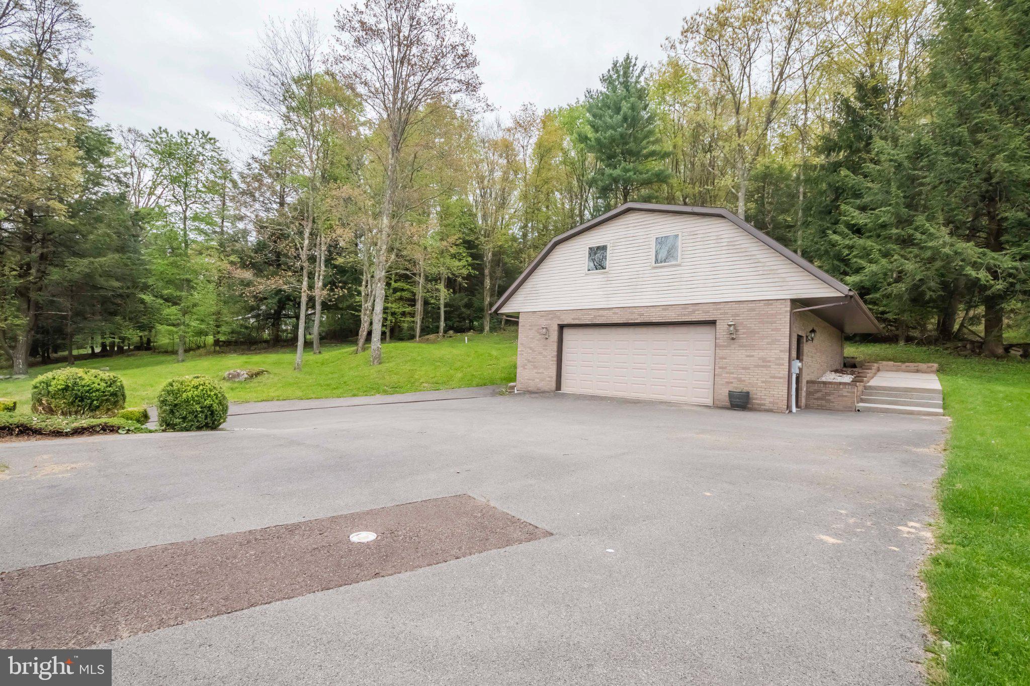 206 Mayhew Inn Road Oakland, MD 21550 - Photo 25 of 31 a front view of a house with a yard and garage