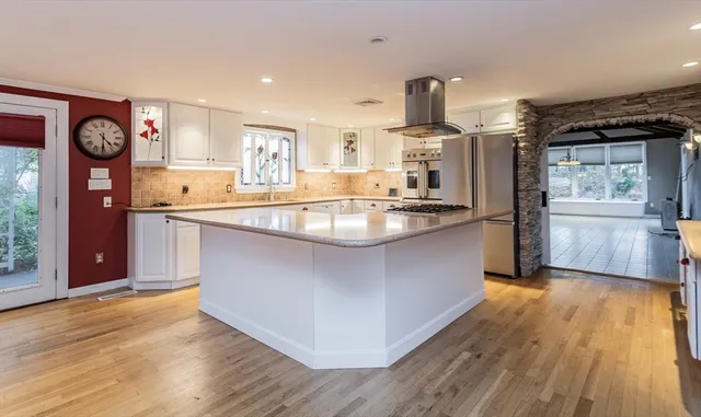 a kitchen with stainless steel appliances granite countertop a stove a sink and a refrigerator