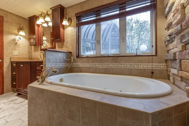 a bath tub sitting in a bathroom next to a window