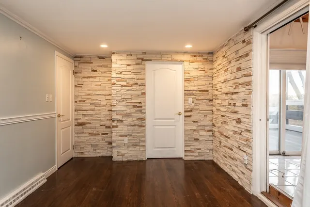 a view of walk in closet with wooden floor