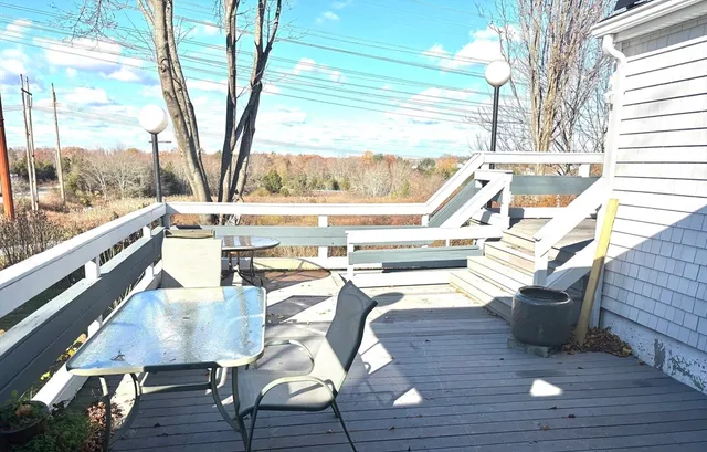 a view of a living room with a floor to ceiling window and wooden floor
