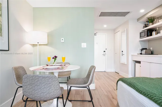 a bed sitting in a bedroom next to a lamp