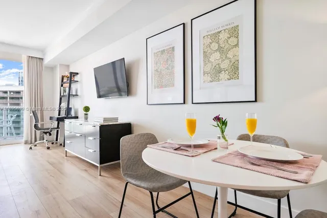 a kitchen with a sink a refrigerator and cabinets