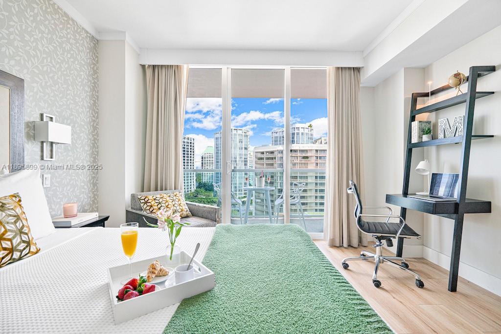 2889 McFarlane Road, Unit 1403 Miami, FL 33133 - Photo 8 of 17 a living room with furniture and a floor to ceiling window