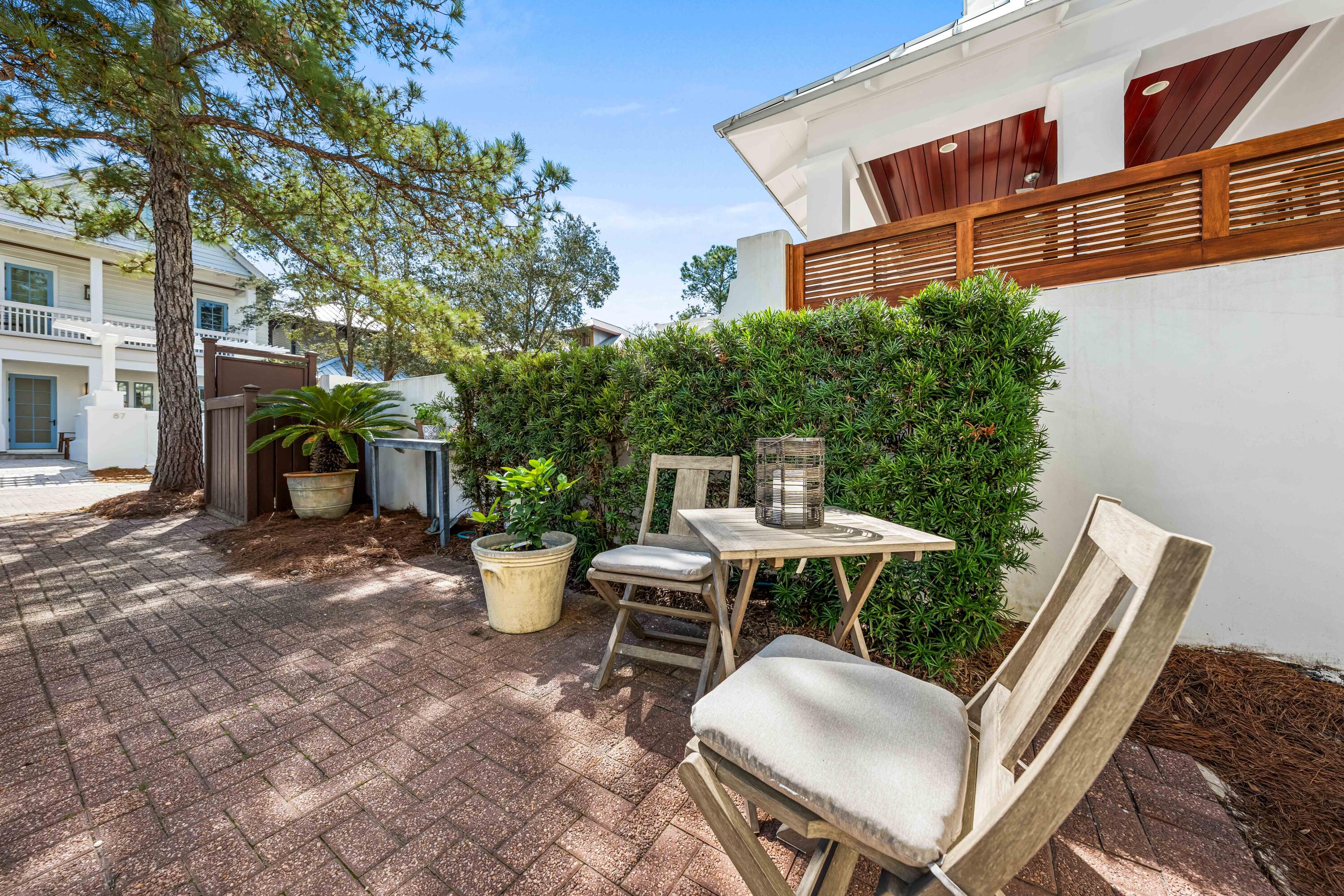 90 Atticus Road Rosemary Beach, FL 32461 - Photo 37 of 51 a view of a patio with table and chairs and potted plants