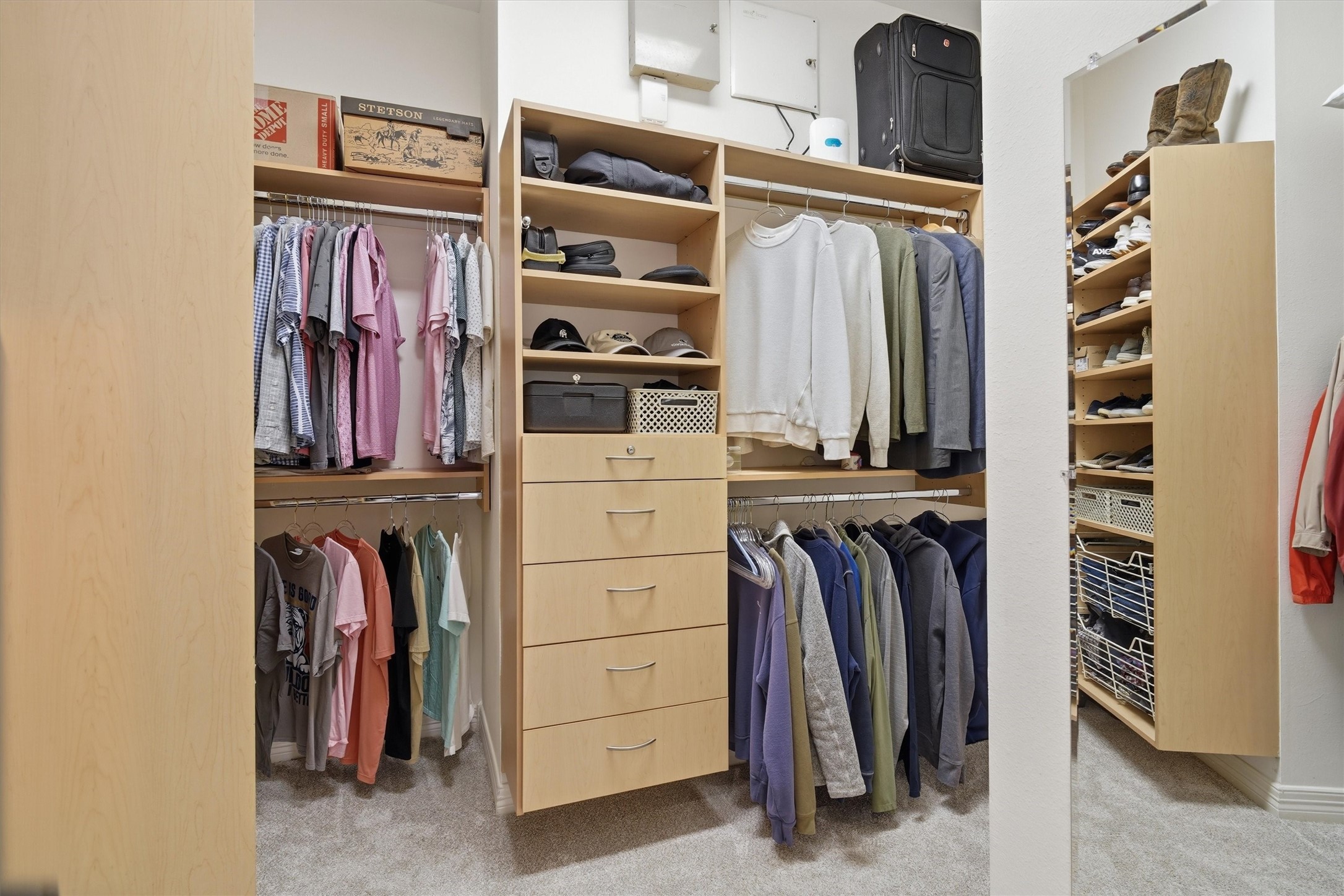 1558 Viejo Road League City, TX 77573 - Photo 14 of 28 Oversized walk-in closet with built-in shelving, drawers, and abundant hanging space.