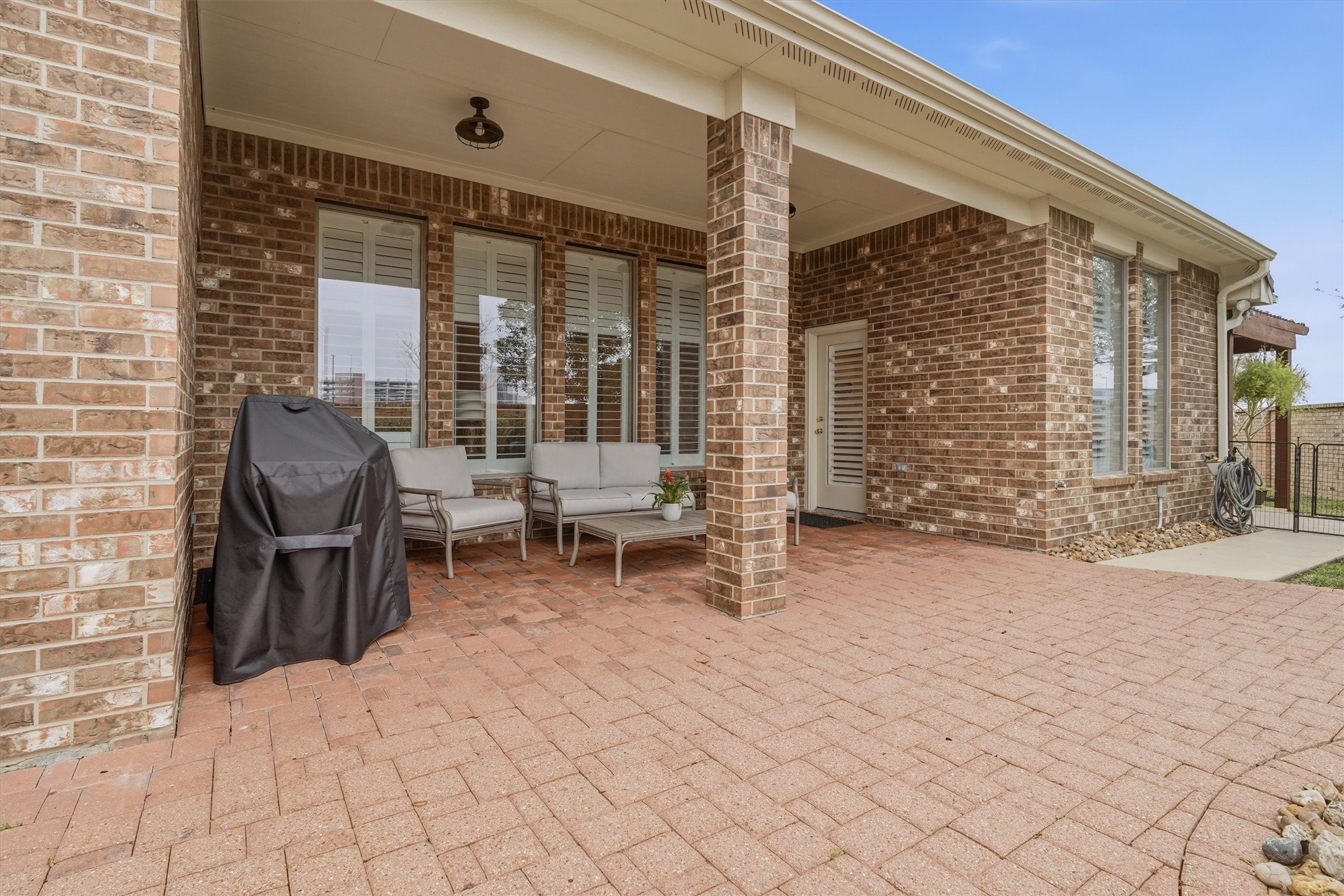1558 Viejo Road League City, TX 77573 - Photo 27 of 28 Covered back patio with brick pavers and multiple seating areas for outdoor enjoyment.