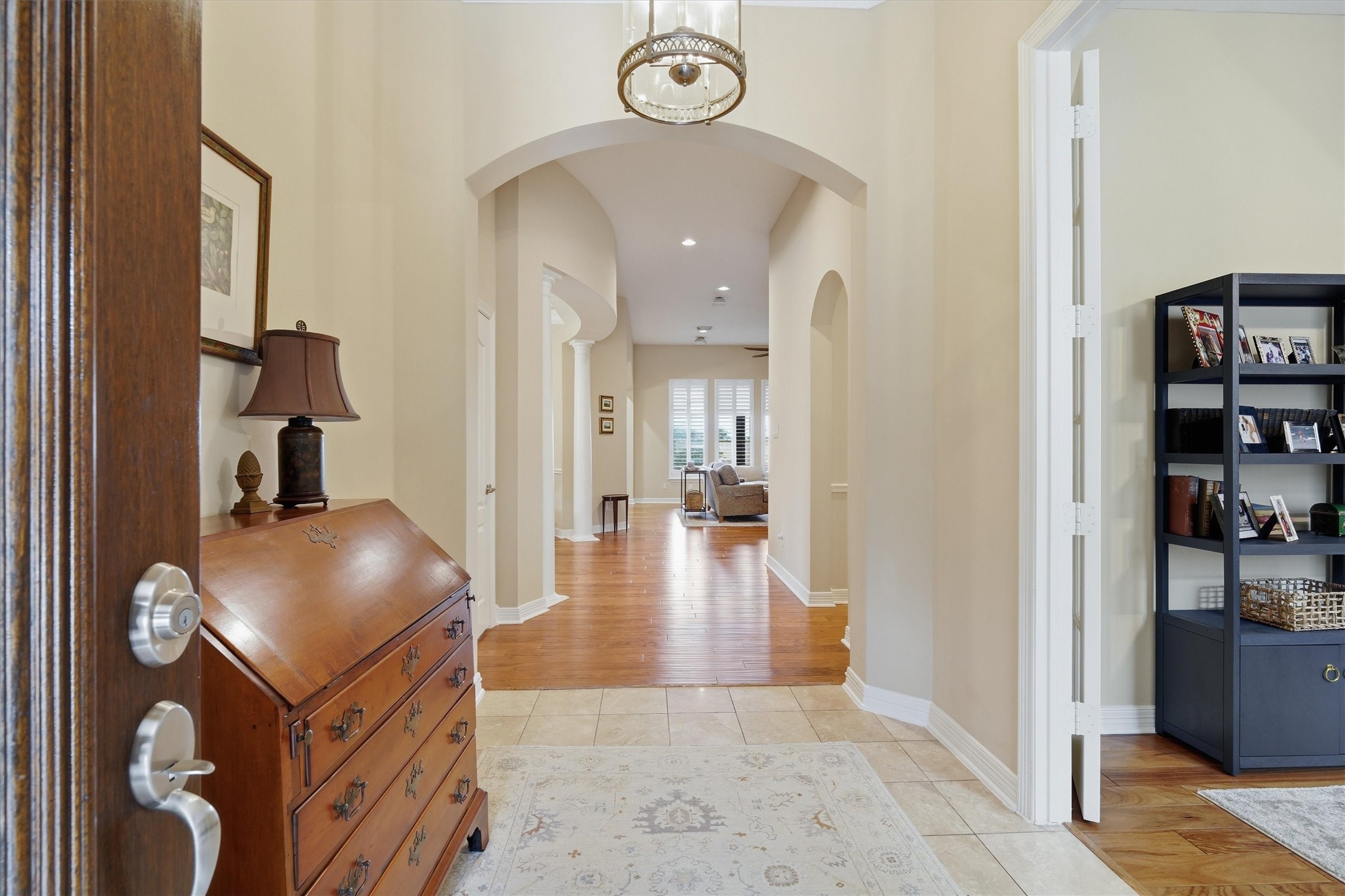 1558 Viejo Road League City, TX 77573 - Photo 4 of 28 Welcoming foyer with tile flooring, arched architectural details, and rich wood floors extending into main living areas.