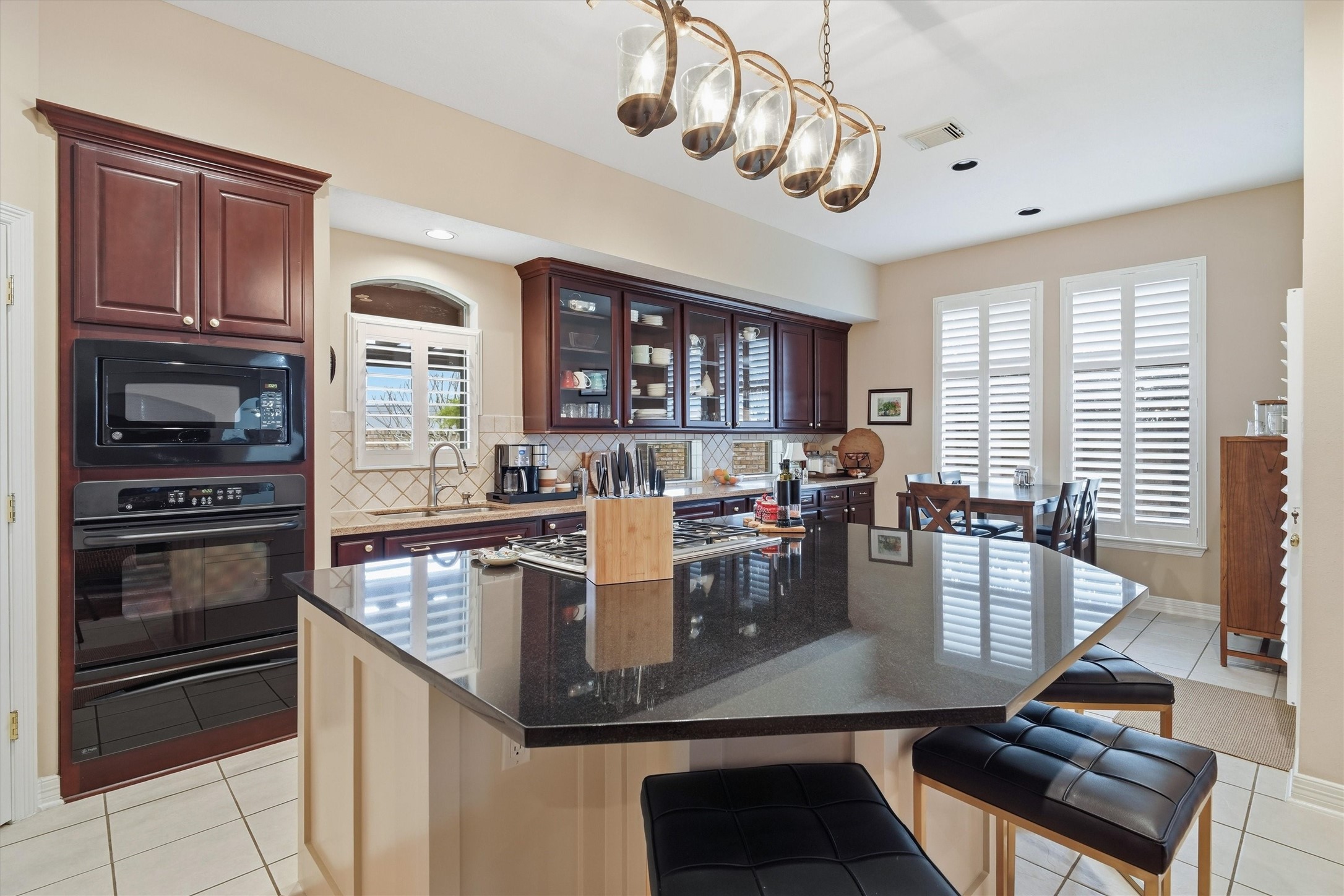 1558 Viejo Road League City, TX 77573 - Photo 8 of 28 Gourmet kitchen featuring granite countertops, gas cooktop, and plantation shutters.