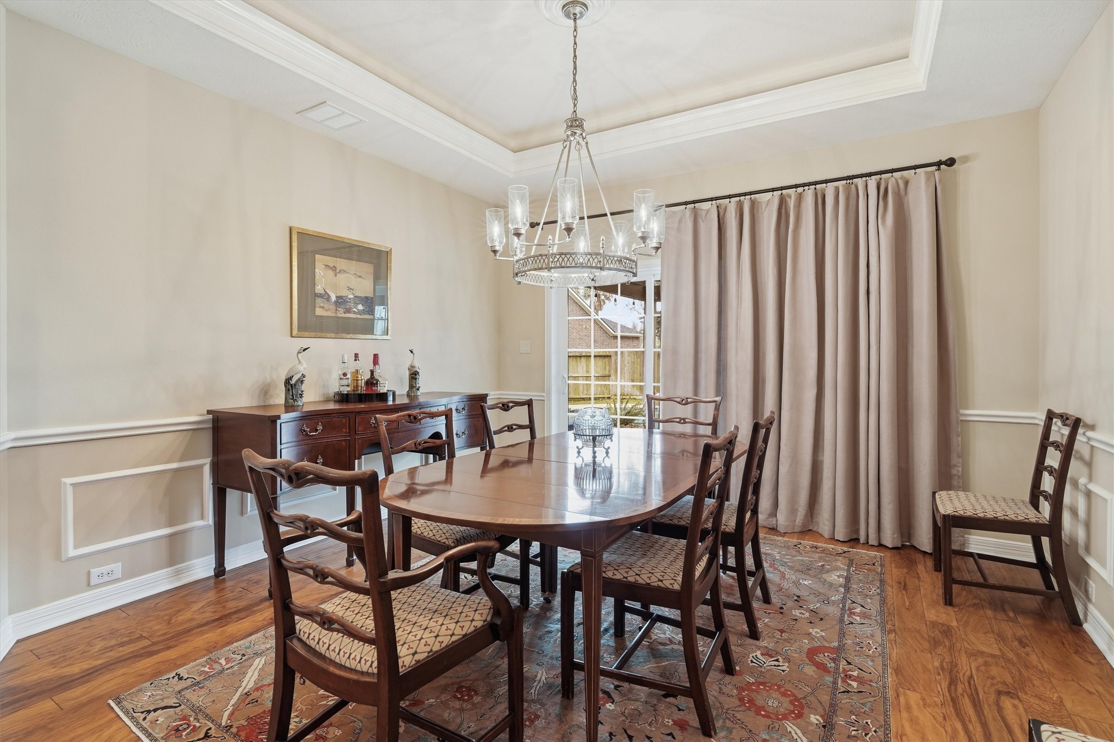 1558 Viejo Road League City, TX 77573 - Photo 9 of 28 Elegant formal dining room with tray ceiling, crown molding, and wood flooring.