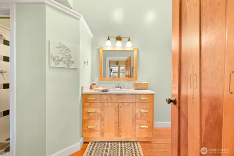a bathroom with a sink a mirror and a window