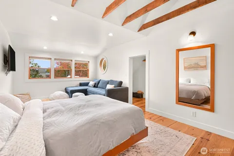 a bedroom with double bed and a window