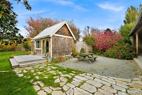 a view of a house with backyard sitting area and garden