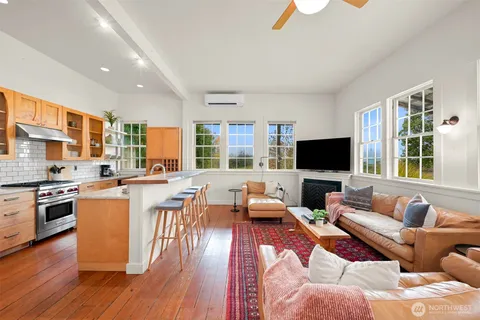 a living room with furniture wooden floor and a flat screen tv