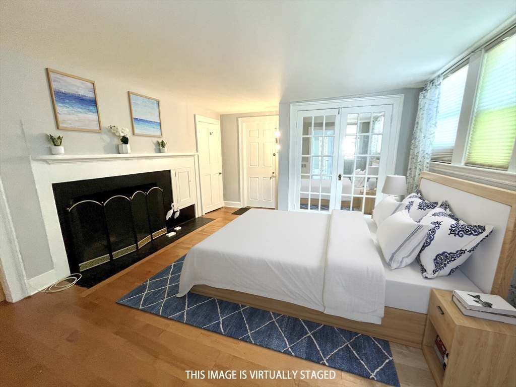 1 Green Street, Unit 2 Marblehead, MA 01945 - Photo 11 of 31 a bedroom with a bed and a fireplace