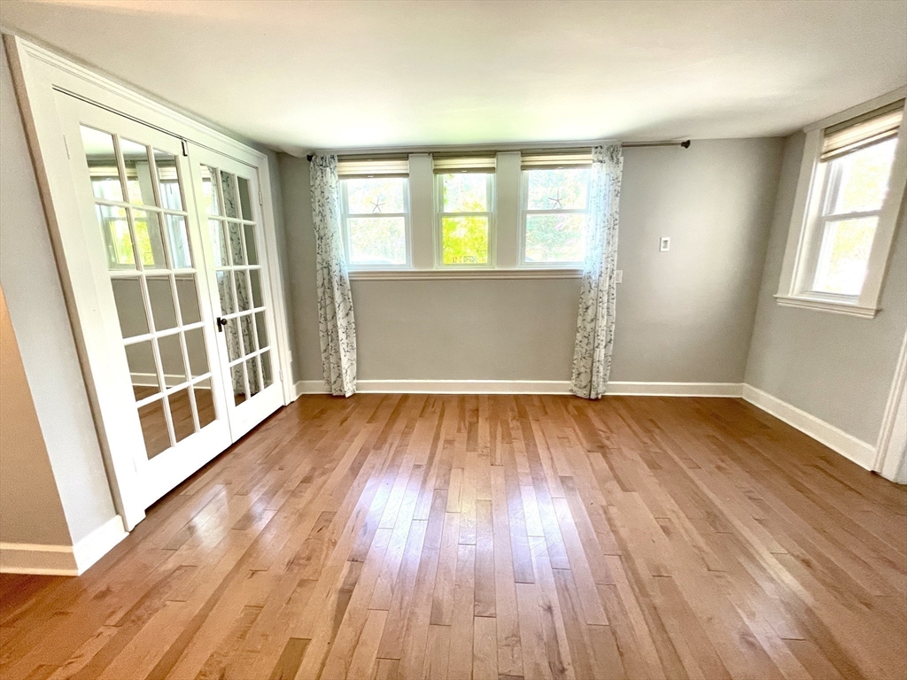 1 Green Street, Unit 2 Marblehead, MA 01945 - Photo 13 of 31 an empty room with wooden floor and windows