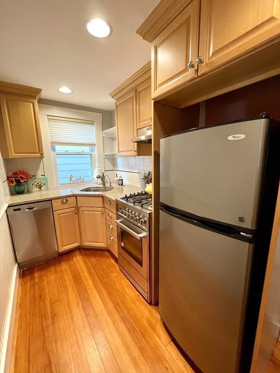 1 Green Street, Unit 2 Marblehead, MA 01945 - Photo 15 of 31 a kitchen with stainless steel appliances a refrigerator sink and cabinets