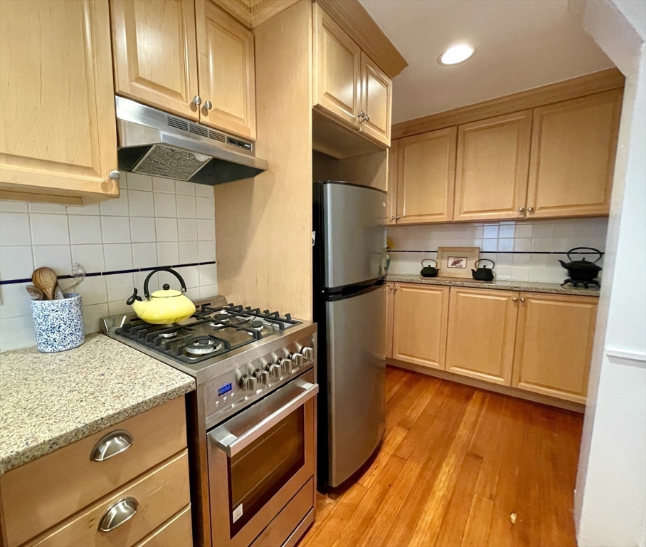 1 Green Street, Unit 2 Marblehead, MA 01945 - Photo 16 of 31 a kitchen with stainless steel appliances granite countertop a stove a sink and a refrigerator