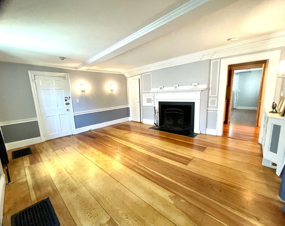 1 Green Street, Unit 2 Marblehead, MA 01945 - Photo 20 of 31 a view of empty room with wooden floor and fireplace