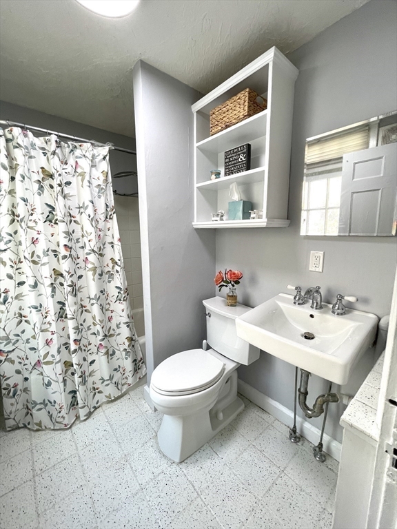 1 Green Street, Unit 2 Marblehead, MA 01945 - Photo 23 of 31 a bathroom with a sink toilet and a mirror
